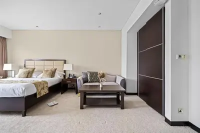a bedroom with a bed and a couch and a table at Amazing 1 Bd Marina View LLC in Dubai
