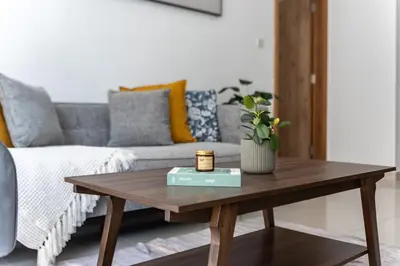 a coffee table in a living room with a couch at ShoresInn - Cozy 1BHK in Dubai Marina in Dubai