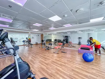 a gym with a man working out in a gym at ShoresInn - Cozy 1BHK in Dubai Marina in Dubai