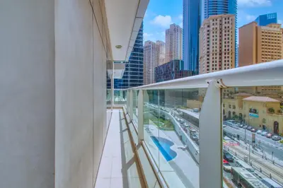 a balcony with a view of a city at ShoresInn - Cozy 1BHK in Dubai Marina in Dubai