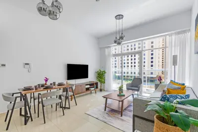 a living room with a couch and a table at ShoresInn - Cozy 1BHK in Dubai Marina in Dubai