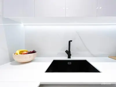 a kitchen counter with a sink and a bowl of fruit at Chic 1-BR Apt & Balcony in Binghatti Heights in Dubai