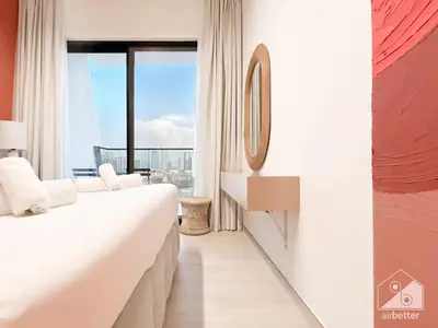 a hotel room with two beds and a window at Chic 1-BR Apt & Balcony in Binghatti Heights in Dubai
