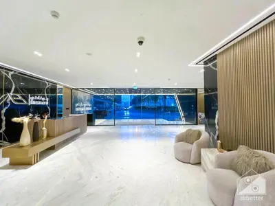 a large room with two white chairs and a table at Chic 1-BR Apt & Balcony in Binghatti Heights in Dubai