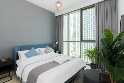 a bedroom with a large bed and a large window at Elite Escape - 1 BHK Getaway Dubai Mall Access - 1509 in Dubai