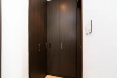 a closet with brown doors in a room at Elite Escape - 1 BHK Getaway Dubai Mall Access - 1509 in Dubai