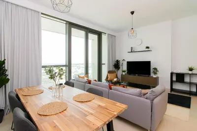 a living room with a table and a couch at Elite Escape - 1 BHK Getaway Dubai Mall Access - 1509 in Dubai