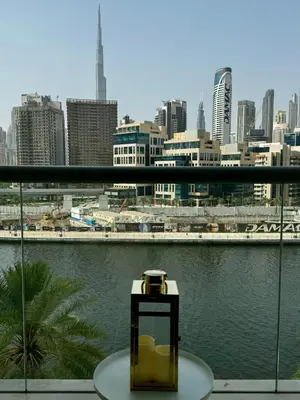 a table on a balcony with a view of a city at Noma Fairview - Burj Khalifa view stunning apartment in Business Bay in Dubai