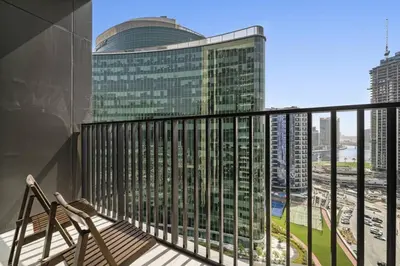 a balcony with a view of a tall building at Spacious Studio In Prime Location in Dubai