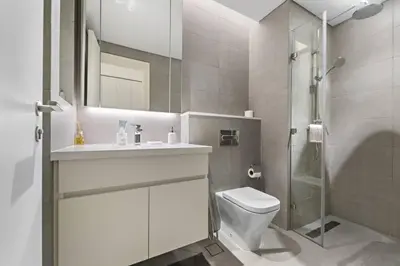 a bathroom with a toilet and a sink and a shower at Spacious Studio In Prime Location in Dubai