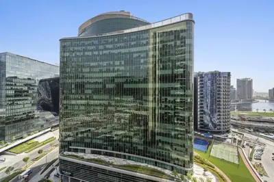 a tall building with glass windows in a city at Spacious Studio In Prime Location in Dubai
