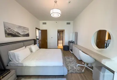 a bedroom with a bed and a mirror at Fabulous Canal Views Al Habtoor City in Dubai