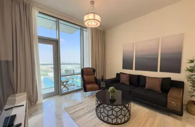 a living room with a couch and a table at Fabulous Canal Views Al Habtoor City in Dubai