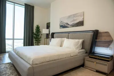a bedroom with a large bed and a large window at Fabulous Canal Views Al Habtoor City in Dubai