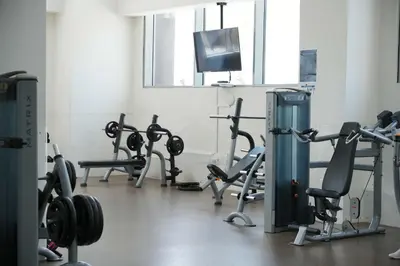 a gym with several rows of exercise bikes and a flat screen tv at Fabulous Canal Views Al Habtoor City in Dubai