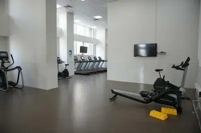 a gym with exercise bikes and a tv in a room at Fabulous Canal Views Al Habtoor City in Dubai