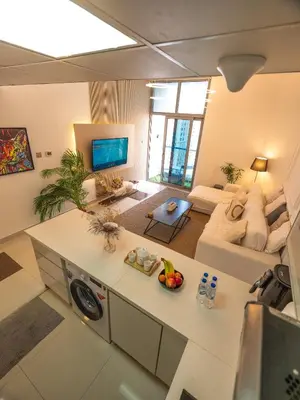 an aerial view of a kitchen and living room at Luxury two bedrooms with Jbr and Marina view apartment in Dubai