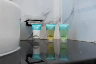 a group of four bottles of sunscreen in a bathroom at The Luxe Marina Experience - Stylish 2BR with Sweeping Balcony Views for Total Relaxation in Dubai