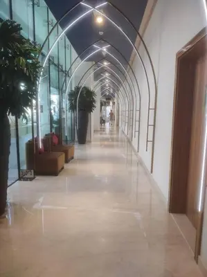 an empty hallway in a building with plants and windows at LeModCasa - Modern Chic studio in Dubai