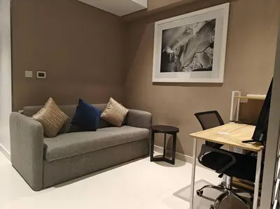 a living room with a couch and a desk at LeModCasa - Modern Chic studio in Dubai