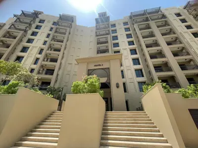 a large building with stairs in front of it at 1BD Partial Burj Al Arab View Prime Location in Dubai