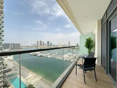 a balcony with a view of the water at Trophy Luxury 1BDR in Emaar Beach Front with Panoramic Sea Views from the Apartment and Private Beach Access in Dubai