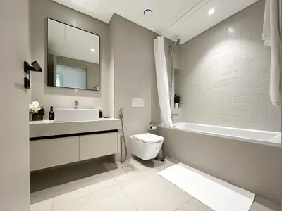 a bathroom with a sink and a toilet and a tub at Trophy Luxury 1BDR in Emaar Beach Front with Panoramic Sea Views from the Apartment and Private Beach Access in Dubai