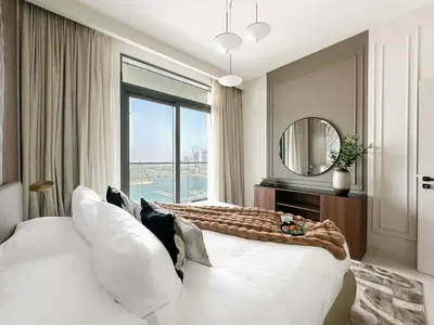 a bedroom with two white beds and a large window at Trophy Luxury 1BDR in Emaar Beach Front with Panoramic Sea Views from the Apartment and Private Beach Access in Dubai