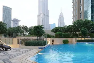 a large swimming pool in the middle of a city at Blueground The Residences gym parking DXB-1348 in Dubai