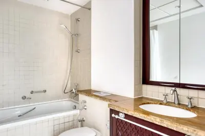 a bathroom with a tub and a sink and a toilet at Blueground Burj Residences BK view pool gym DXB-1131 in Dubai