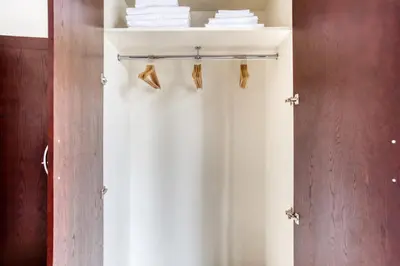 a closet with a white curtain and towels at Blueground Burj Residences BK view pool gym DXB-1131 in Dubai