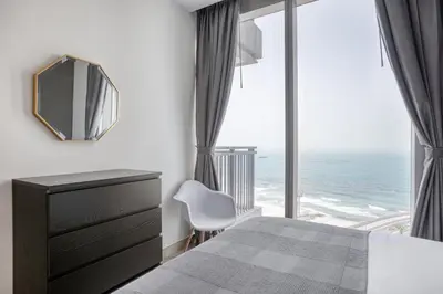 a bedroom with a view of the ocean at Blueground 5242 Tower sea view doorman pool DXB-867 in Dubai