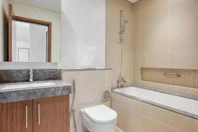 a bathroom with a toilet and a tub and a sink at Blueground 5242 Tower sea view doorman pool DXB-867 in Dubai