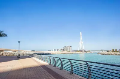 a walkway next to a body of water at Blueground 5242 Tower sea view doorman pool DXB-867 in Dubai