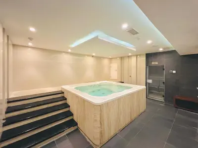 a jacuzzi tub in a room with a staircase at Waves - Executive Bay Studio, Canal View and Modern Amenities in Dubai