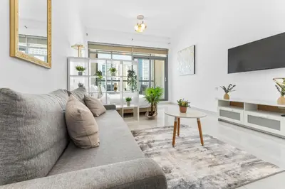 a living room with a couch and a table at Waves - Executive Bay Studio, Canal View and Modern Amenities in Dubai