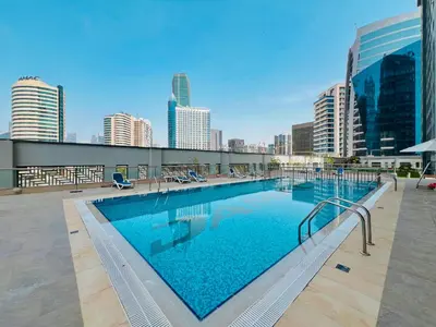 a large swimming pool on top of a building at Waves - Executive Bay Studio, Canal View and Modern Amenities in Dubai