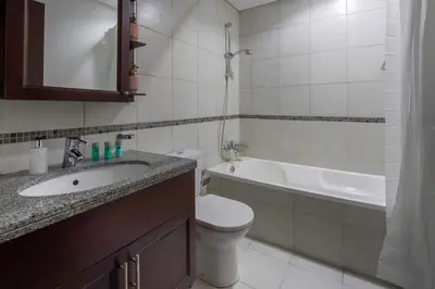 a bathroom with a sink and a toilet and a tub at Frank Porter - Arno A in Dubai