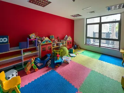 a childs room with red walls and toys in it at Frank Porter - Arno A in Dubai