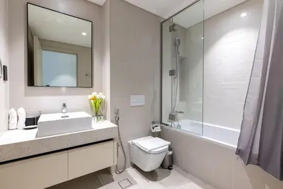 a bathroom with a sink and a toilet and a shower at Beachfront Holiday 1BR Sea Marina Views in Dubai