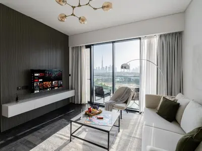 a living room with a white couch and a glass table at Stylish 1BR with Dubai Skyline & Burj Khalifa View in Dubai