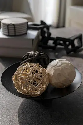 a black plate with two balls of food on it at Stylish 1BR with Dubai Skyline & Burj Khalifa View in Dubai