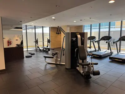 a gym with cardio equipment in a building at Stylish 1BR with Dubai Skyline & Burj Khalifa View in Dubai