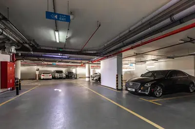 a parking garage with several cars parked in it at Binghatti Gateway Family 2BR with Balcony, Close to Dubai Mall & Burj Khalifa by Simply Comfort in Dubai