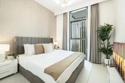 a bedroom with a large bed and a large window at High-Rise Chic, Burj Crown, Opera Boulevard View, by Dubai Mall in Dubai