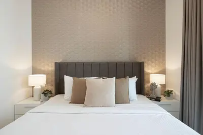 a bedroom with a large bed with white sheets and pillows at High-Rise Chic, Burj Crown, Opera Boulevard View, by Dubai Mall in Dubai