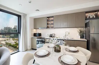 a kitchen with a table and a large window at High-Rise Chic, Burj Crown, Opera Boulevard View, by Dubai Mall in Dubai