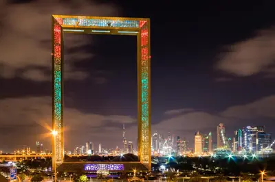 a lit up arch in front of a city at night at High-Rise Chic, Burj Crown, Opera Boulevard View, by Dubai Mall in Dubai