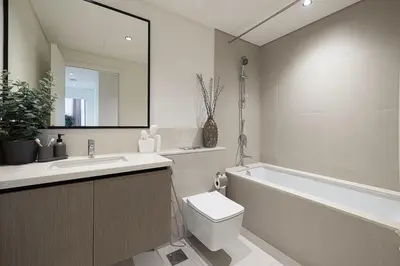 a bathroom with a tub and a toilet and a sink at High-Rise Chic, Burj Crown, Opera Boulevard View, by Dubai Mall in Dubai