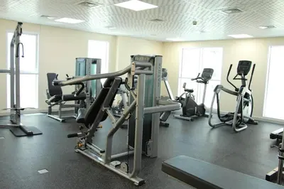 a gym with several exercise bikes and tread machines at Nice studio in JVT - Al Manara Tower - Dubai in Dubai